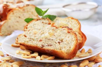 Slices of sweet braided bread and blanched almonds