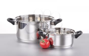 Two shiny stainless steel pots