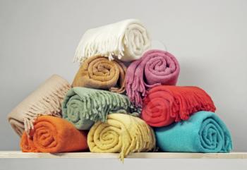 Heap of rolled up blankets
 on a shelf