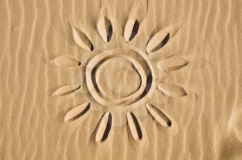 Sun drawn in the sand - closeup view