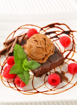 Chocolate brownie with ice cream and fresh raspberries
