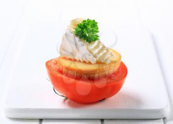 Halved tomato with smoked cheese and camembert