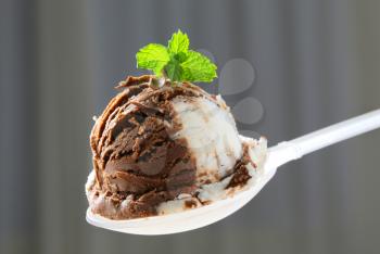 Scoop of vanilla chocolate ice cream on spoon