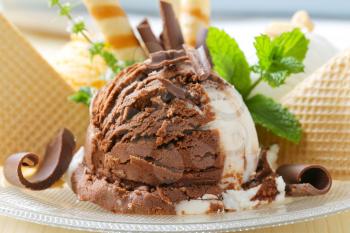 Chocolate vanilla ice cream garnished with wafers and chocolate curls