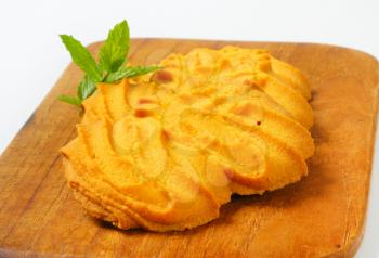 Spritz butter cookies on cutting board