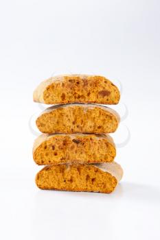 Halved gingerbread biscuits on white background