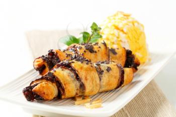 Chocolate-filled croissants and scoop of ice cream on plate