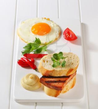 Grilled meatloaf sandwich, fried egg and mustard 