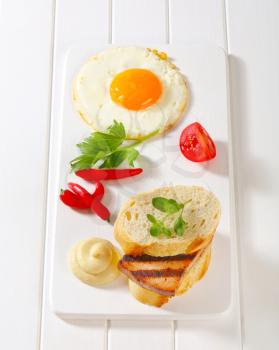 Grilled meatloaf sandwich, fried egg and mustard 