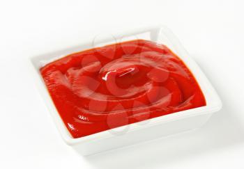 Smooth tomato passata in a small square dish