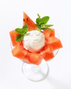 Scoop of white ice cream with diced watermelon