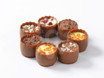Delicate milk chocolate cups with liqueur and ganache centres