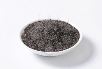 Whole poppy seeds on plate