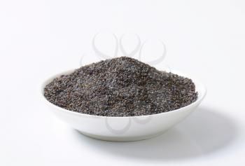 Whole poppy seeds on plate