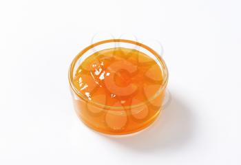 Apricot jam in small glass bowl