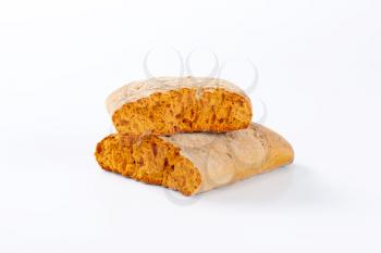 Halved gingerbread biscuit on white background