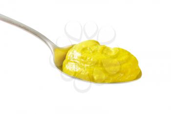 American yellow mustard on metal spoon