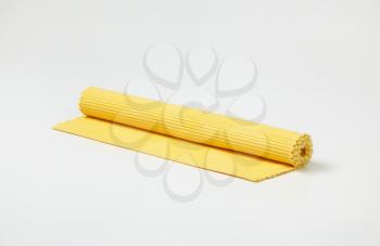 yellow ribbed cotton placemat, rolled up
