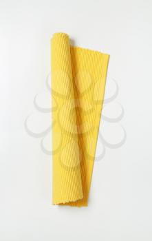 yellow ribbed cotton placemat, rolled up