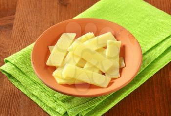 bowl of sliced bamboo shoots on green tablecloth