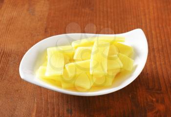bowl of sliced bamboo shoots on wooden table