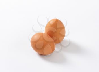 two organic eggs on white background