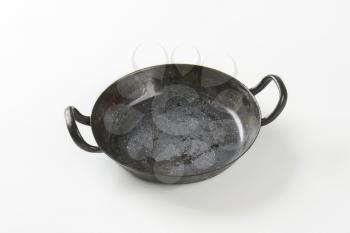 Empty black skillet / paella pan with loop handles
