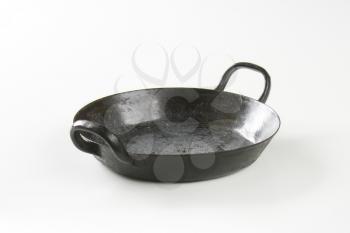 Empty black skillet / paella pan with loop handles