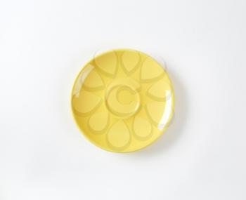 Small round yellow ceramic saucer