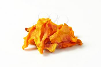 Heap of dried mango slices on white background
