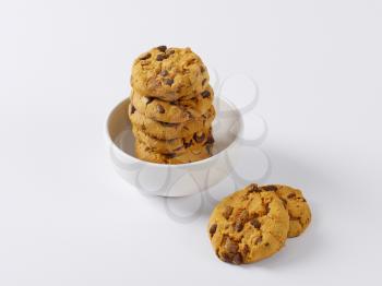 stack of chocolate chip cookies in white bowl