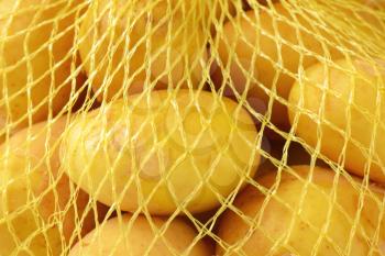 detail of new potatoes in net packaging