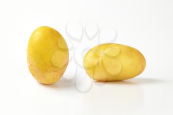 two new potatoes on white background