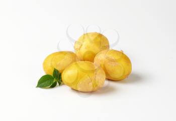 four new potatoes on white background