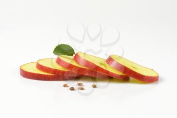 fresh apple slices in a row on white background