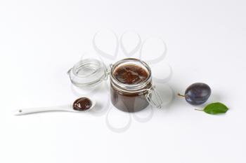 plum preserve in a jar and on spoon