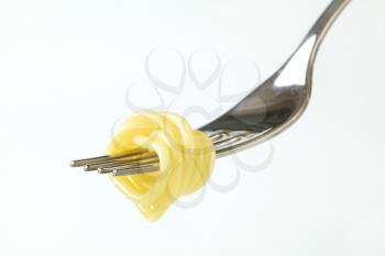 Cooked spaghetti twirled on fork