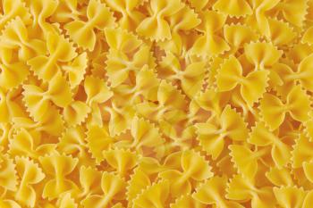 Background of uncooked bow tie pasta