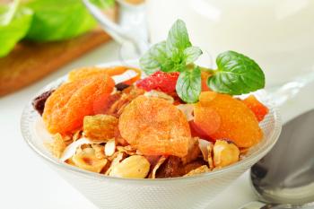 Bowl of rolled oats with various dried fruit pieces and nuts