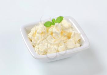 white creamy cheese in a small bowl