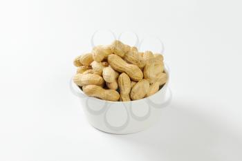 Bowl of raw unshelled peanuts
