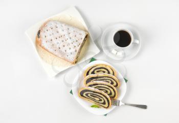sliced poppy seed roll and cup of coffee