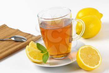 hot tea in glass mug and fresh lemon