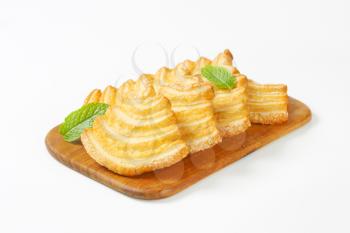 Italian puff pastry cookies coated with sugar on a cutting board