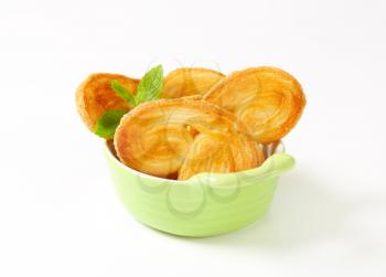 Elephant ear cookies coated with sugar in a bowl