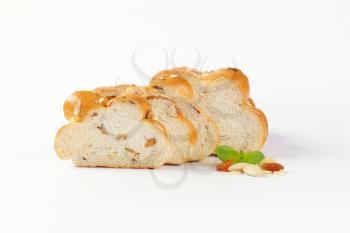 sliced loaf of Christmas sweet braided bread with almonds and raisins