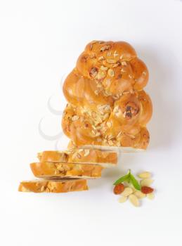 sliced loaf of Christmas sweet braided bread with almonds and raisins