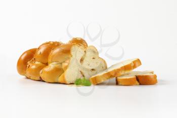 sliced sweet braided bread on white background