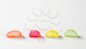 sliced fruit jelly candies on white background