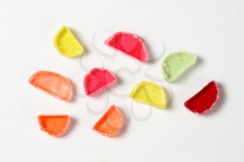 sliced fruit jelly candies on white background